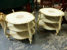A PAIR OF CREAM AND GILT DECORATED ITALIANATE THREE TIER LAMP TABLES.