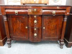 AN EARLY 19th.C.MAHOGANY SIDEBOARD WITH ARRANGEMENT OF DRAWERS AND CABINETS FLANKED BY TURNED