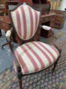 A SHERATON TASTE MAHOGANY SHIELD BACK ELBOW CHAIR WITH LEAF CARVED SHOW FRAME, THE BACK, ELBOW RESTS