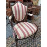 A SHERATON TASTE MAHOGANY SHIELD BACK ELBOW CHAIR WITH LEAF CARVED SHOW FRAME, THE BACK, ELBOW RESTS
