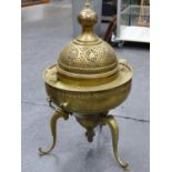 A PERSIAN BRASS BRAZIER WITH PIERCED DOME COVER AND CARRYING HANDLES, TRIFID SCROLL LEGS. H. 92cms.