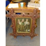 A VINTAGE TRAMP ART TYPE CORK FRAME ENCLOSING AN IMAGE OF THREE BOYS. 80 x 74cms. TOGETHER WITH AN
