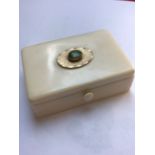 A SMALL ANTIQUE IVORY TRINKET BOX WITH HINGED LID CENTERED WITH YELLOW METAL AND GREEN CABUCHON