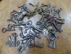 A COLLECTION OF ANTIQUE AND LATER KEYS, PADLOCKS AND HANDLES, SOME CONTAINED IN A PINE BOX.