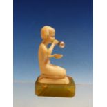 A FINE ART DECO CARVED IVORY FIGURE OF A CHILD BLOWING BUBBLES. MOUNTED ON GEEN MARBLE BASE 8CM