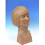 A TERRACOTTA BUST OF A GIRL INCISED J BRIDGER 67 ON HER RIGHT SHOULDER. H 36cms.