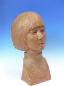 A TERRACOTTA BUST OF A GIRL INCISED J BRIDGER 67 ON HER RIGHT SHOULDER. H 36cms.