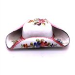A WHITE ENAMEL TRICORN HAT SNUFF BOX PAINTED WITH COLOURED FLOWERS AND A CROWNED ARMORIAL ON THE