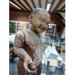AN INTERESTING ANTIQUE CARVED AND PAINTED ASIAN STANDING FIGURE OF A BOY. OVERALL HEIGHT 81cms.