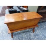 AN AMERICAN MAPLE HINGED TOP WORK BOX ON TURNED LEG STAND. H. 62 x W. 82cms.