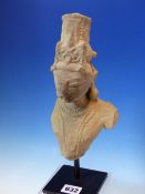 AN ANTIQUE FAR EASTERN CARVED STONE BUST FRAGMENT OF A DEITY LATER MOUNTED ON DISPLAY SATND. THE