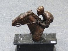 A BRONZE OF JOCKEY AND HORSE ON MARBLE PLINTH.