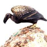 A FINELY MODELLED MINIATURE SILVERED AND GILT BRONZE VULTURE, MOUNTED UPON A NATURAL ROCKY BASE..7