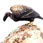 A FINELY MODELLED MINIATURE SILVERED AND GILT BRONZE VULTURE, MOUNTED UPON A NATURAL ROCKY BASE..7