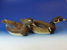 A PAIR OF CARVED AND PAINTED DUCK DECOYS . A MALE AND FEMALE WOOD DUCK, EACH SIGNED AND INSCRIBED ON