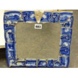 A DECORATIVE SMALL MIRROR FRAMED WITH VICTORIAN BLUE PATTERNED CHINA FRAGMENTS. H. 32.5 x W. 31cms.