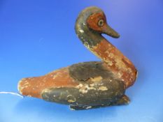 AN ANCIENT EGYPTIAN CARVED AND POLYCHROMED WOODEN FIGURE OF A DUCK. H. 18cms.