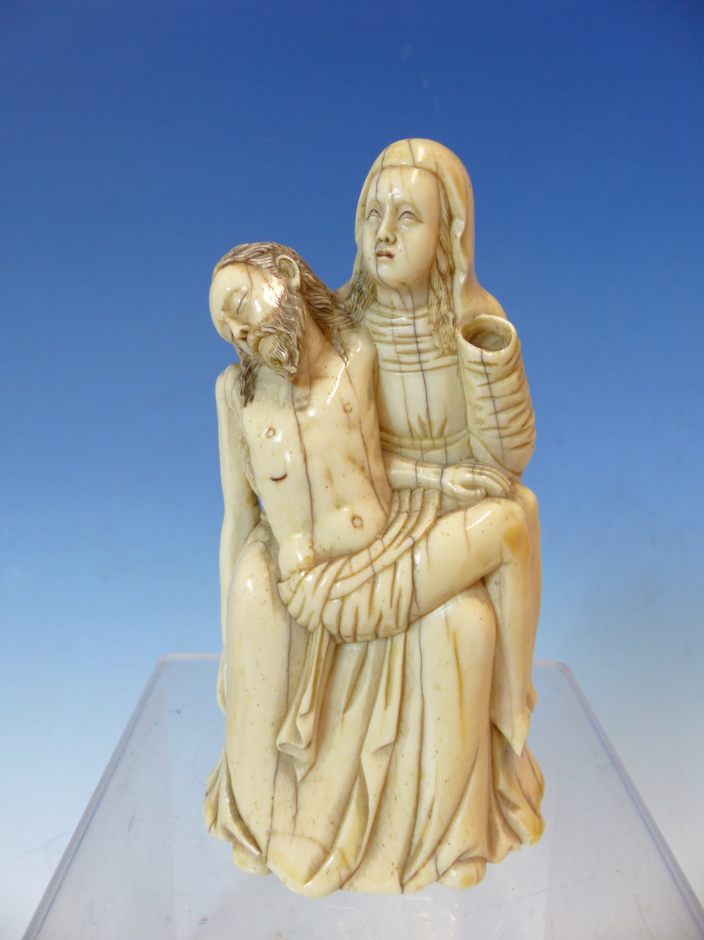 AN 18TH CENTURY CARVED IVORY FIGURE GROUP OF THE VIRGIN HOLDING THE DEAD CHRIST. PROBABLY GERMAN. 12