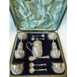 A SILVER HALLMARKED CASED CONDIMENT SET TO INCLUDE TWO PEPPERS, FOUR SALTS AND A MUSTARD POT.