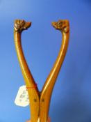 TREEN, A FINELY CARVED 19th.C. BOXWOOD GLOVE STRETCHER WITH DOG HEAD HANDLES TOGETHER WITH A CARVED