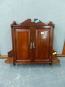 AN EDWARDIAN CARVED WALNUT TWO DOOR HANGING CUPBOARD. H. 58 x W. 70cms.