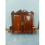 AN EDWARDIAN CARVED WALNUT TWO DOOR HANGING CUPBOARD. H. 58 x W. 70cms.