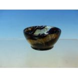 A SMALL BLUE JOHN POLISHED BOWL, A STRIATED STONE KNIFE HANDLE, A WHITE JADE PENDANT, A GREEN JADE