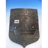 AN ANTIQUE HEAVY BRONZE SHIELD FORM PLAQUE DEPICTING SAILING BOAT UNDER STONE ARCH BRIDGE. 27cm HIGH