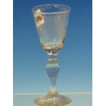 A GERMAN WINE GLASS, THE BOWL WHEEL ENGRAVED WITH A STAG THE BALUSTER STEM ABOVE A CIRCULAR FOOT.