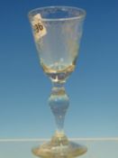 A GERMAN WINE GLASS, THE BOWL WHEEL ENGRAVED WITH A STAG THE BALUSTER STEM ABOVE A CIRCULAR FOOT.