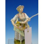 A MEISSEN PORCELAIN FIGURE OF A LADY HOLDING A BASKET OF ROSES, HER HAT AND DRESS TRIMMED WITH LACE,