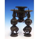 A JAPANESE BRONZE PRICKET CANDLESTICK GARNITURE, EACH PIECE WITH MASK AND TONGUE HANDLES AND CAST