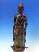 A CHINESE CHAMPLEVE ENAMELLED BRONZE FIGURE OF THE BUDDHA STANDING HOLDING A LOTUS FLOWER. H.41cms.