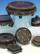 A COLLECTION OF HARD WOOD VASE AND PLATE STANDS TOGETHER WITH TWO CHINESE VASE COVERS.