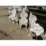 A SET OF FOUR CAST IRON VICTORIAN STYLE GARDEN CHAIRS.