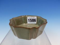 A CHINESE GUAN TYPE SHALLOW BOWL, THE HEXAFOIL SHAPE WITH A CRACKLED GREY GREEN GLAZE OVERALL. W