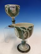 A PAIR OF ALAN CAIGER SMITH ALDERMASTON POTTERY GOBLETS PAINTED WITH OLIVE GREY SCROLLS ON A WHITE