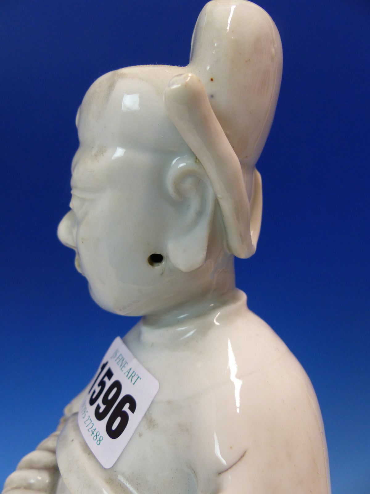 A BLANC DE CHINE FIGURE OF A FIERCE EYED MANDARIN STANDING ON A DOUBLE CLOUD PLINTH, HIS CHIN - Image 18 of 48