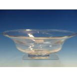AN 1981 ORREFORS CLEAR GLASS BOWL DESIGNED BY SIMON GATE, THE SHAPED OVAL RIM ROLLED OVER TO FORM