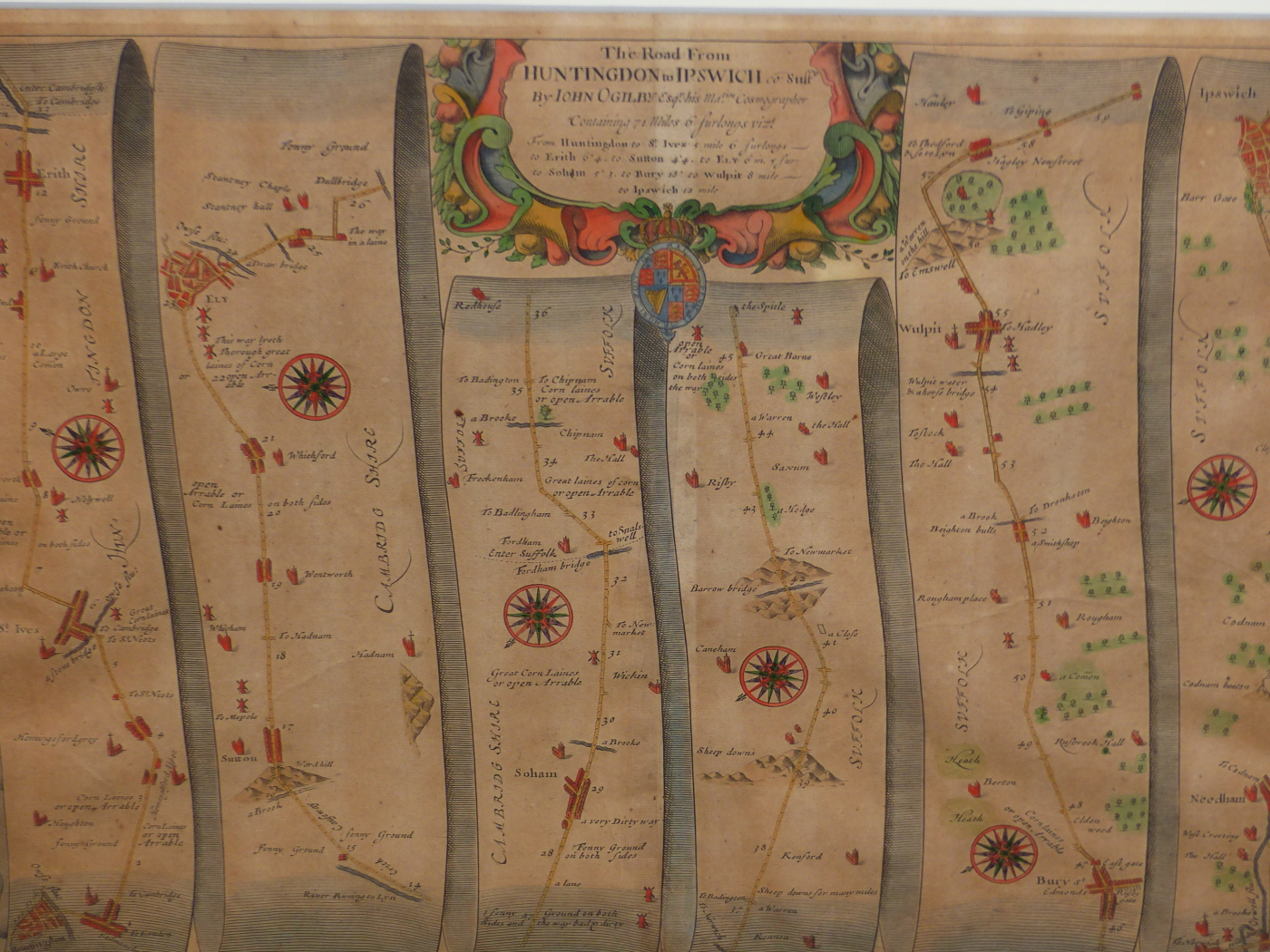 AFTER JOHN OGILBY. AN ANTIQUE HAND COLOURED MAP, THE ROAD FROM HUNTINGDON TO IPSWICH. 35 x 46.5cms.
