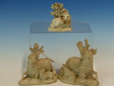 A PAIR OF BISCUIT PORCELAIN RECLINING SHEEP, POSSIBLY MINTON, EACH WITH A LAMB AND BACKED BY A