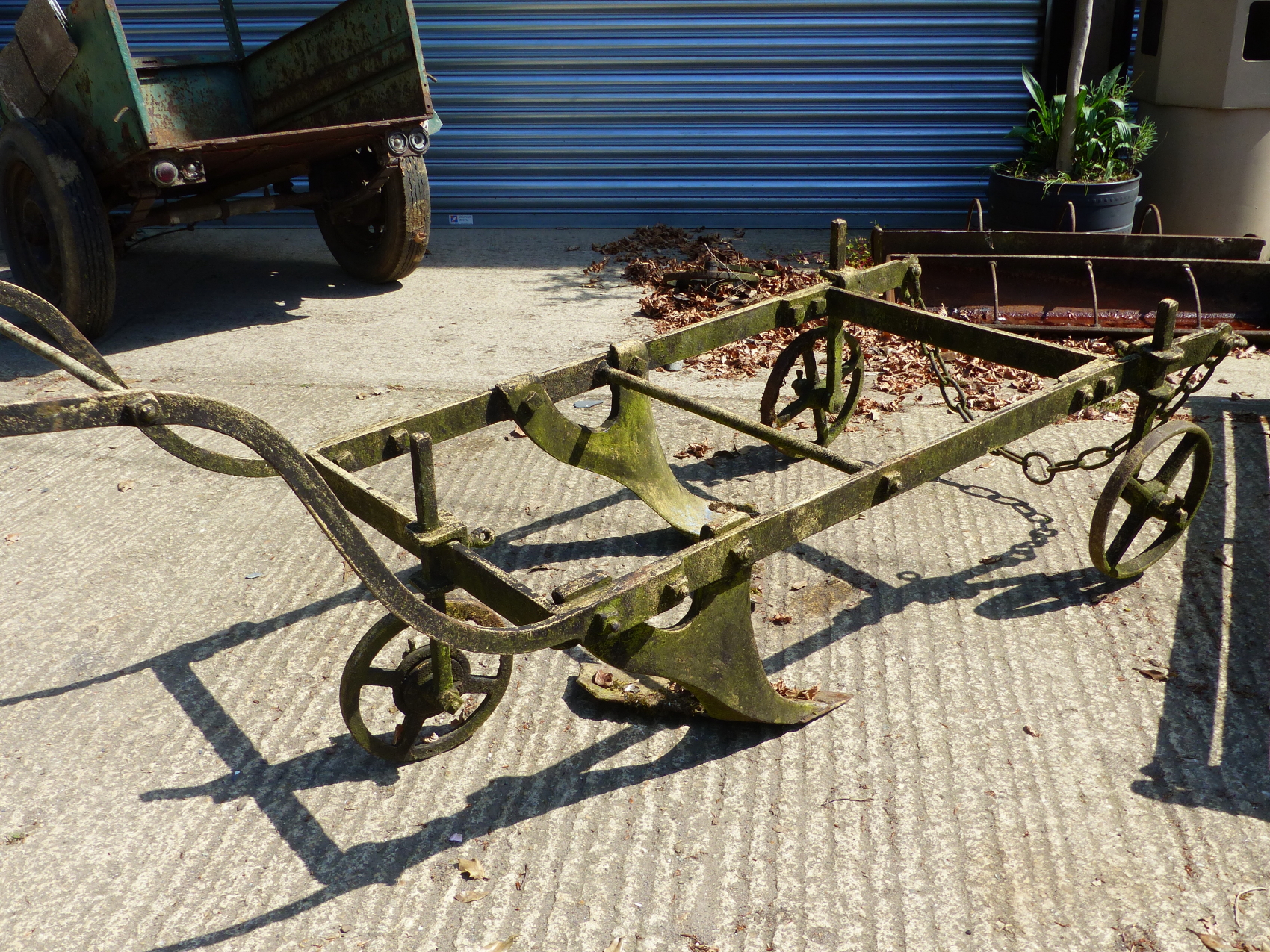 A LARGE ANTIQUE TWO FURROW PLOUGH.