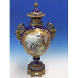 AN ORMOLU MOUNTED SEVRES BLUE GROUND VASE AND COVER, ONE SIDE PAINTED WITH A MAN READING TO TWO
