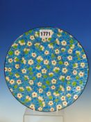 A LONGWY PLATE DEORATED IN CLOISONNE STYLE WITH SPRING BLOSSOMS ON THE CRACKING ICE OF WINTER,