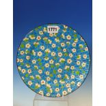 A LONGWY PLATE DEORATED IN CLOISONNE STYLE WITH SPRING BLOSSOMS ON THE CRACKING ICE OF WINTER,