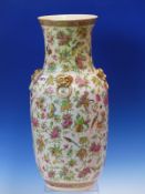 A CANTON VASE WITH FOUR GILT MASK AND RING HANDLES ON THE SHOULDERS AGAINST A GROUND OF FLOWERS,