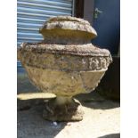 A SET OF FOUR CLASSICAL STYLE SWAG DECORATED COMPOSITE STONE GARDEN URNS, H 55cms.