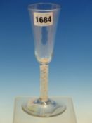 AN 18th C. ENGLISH OPAQUE TWIST ALE GLASS WITH SLENDER CONICAL BOWL AND ON CIRCULAR FOOT. H 17.