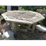 A LARGE OCTAGONAL TEAK GARDEN TABLE AND SIX CHAIRS TOGETHER WITH A SMALLER GARDEN TABLE.