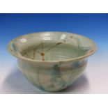 AN EARLY CARTER, POOLE POTTERY BOWL GLAZED IN TONES OF TURQUOISE AND GREY, THE INSIDE RIM MOULDED IN